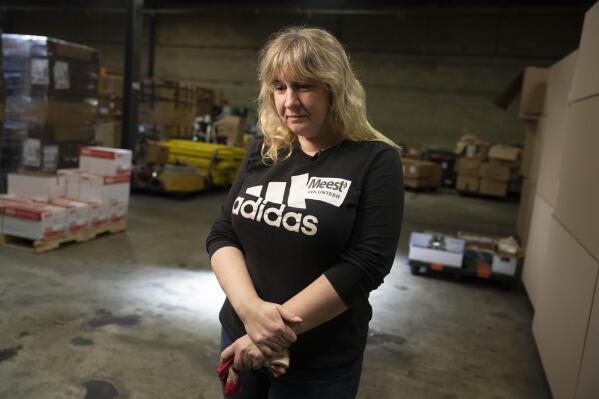 Valeriya Roshkovan pauses during an interview as she volunteers for Razom for Ukraine, a New York-based nonprofit, to help package donated firefighting equipment to ship to her country, Wednesday, Feb. 8, 2023, in Woodbridge Township, N.J. (AP Photo/John Minchillo)