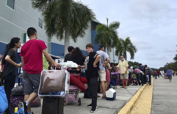 
              Thousands of people wait in line to get into a Hurricane Irma shelter at the Germain Arena in Estero, Fla., on Saturday, Sept. 9, 2017. (AP Photo/Jay Reeves)
            