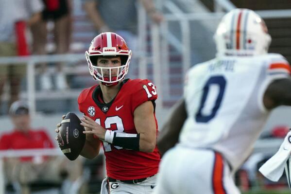 Georgia quarterback Stetson Bennett (13) looks for an open receiver during the second half of an NCAA college football game against Auburn, Saturday, Oct. 8, 2022, in Athens, Ga. (AP Photo/John Bazemore)