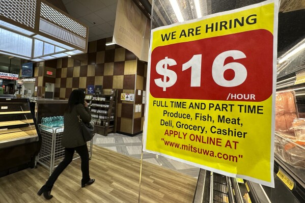 A hiring sign is displayed at a grocery store in Arlington Heights, Ill., Tuesday, Oct. 10, 2023. On Thursday, the Labor Department reports on the number of people who applied for unemployment benefits last week. (AP Photo/Nam Y. Huh)