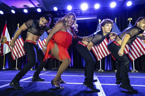 Drag performer Velvet LeNore joins dancers on stage during the gala at the Florida Democratic Party's Annual Leadership Blue Weekend at the Fontainebleau Hotel on Miami Beach, Fla., Saturday, July 8, 2023. (Al Diaz/Miami Herald via AP)