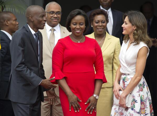 FILE - In this May 23, 2018, file photo, Haiti's President Jovenel Moise, left, and First Lady Martine Moise, in red, receive Spain's Queen Letizia Ortiz at the national Palace in Port-au-Prince, Haiti, Wednesday, May 23, 2018. Moïse was assassinated after a group of unidentified people attacked his private residence, the country’s interim prime minister said in a statement Wednesday, July 7, 2021. Moïse's wife, First Lady Martine Moïse, is hospitalized, interim Premier Claude Joseph said. (AP Photo/Dieu Nalio Chery, File)