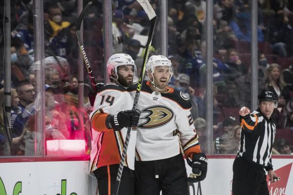 Anaheim Ducks' Adam Henrique, left, and Kevin Shattenkirk celebrate Henrique's goal against the Vancouver Canucks during the second period of an NHL hockey game Saturday, Feb. 19, 2022, in Vancouver, British Columbia. (Darryl Dyck/The Canadian Press via AP)