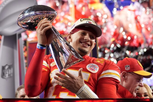 FILE - Kansas City Chiefs quarterback Patrick Mahomes celebrates with the trophy after the team's win in overtime during the NFL Super Bowl 58 football game against the San Francisco 49ers, Sunday, Feb. 11, 2024, in Las Vegas. Mahomes and the Chiefs are aiming to become the first team to three-peat since the 1965-67 Green Bay Packers won three consecutive NFL championships. (AP Photo/Ashley Landis, File)