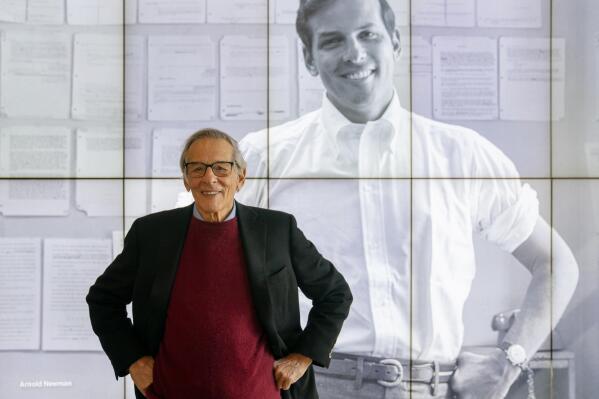 FILE - Author and biographer Robert Caro stands beside an image of his younger self after touring a permanent exhibit in his honor, "Turn Every Page": Inside the Robert A. Caro Archive, at the New York Historical Society Museum & Library in New York on Oct. 20, 2021. Caro’s very long-awaited next book is that he knows the final words. The bad news is that he’s known them for years and remains far from concluding his Lyndon Johnson series, for which he has published four volumes over a period of 40 years. Vol. 4, “The Passage of Power,” came out in 2012. The fifth volume is expected to cover Johnson’s first full year as president and continue through the end of his presidency, 1969, and his death four years later. Caro says the fifth book will be “big.” (AP Photo/John Minchillo, File)