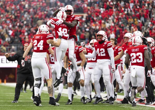 Nebraska's Jaylen Lloyd, second from front left, leaps into the arms of teammate Malachi Coleman after running in a 73-yard touchdown pass against Purdue during the first half of an NCAA college football game Saturday, Oct. 28, 2023, in Lincoln, Neb. (AP Photo/Rebecca S. Gratz)