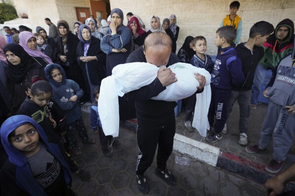 A Palestinian morns a relative killed in the Israeli bombing of the Gaza Strip in Deir al Balah, Gaza Strip, on Sunday, Feb. 11, 2024. (AP Photo/Adel Hana)