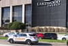 Emergency vehicles are parked on a feeder road outside a Lakewood church during a reported active shooter incident in Houston on Sunday, Feb. 11, 2024.  (Kirk Sides/Houston Chronicle via AP)