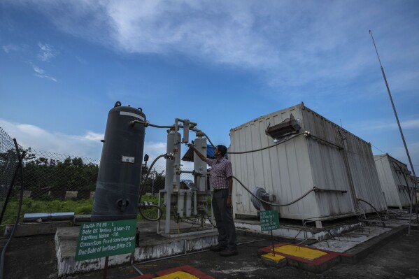 An officer checks a part of a hydrogen plant at Oil India Limited in Jorhat, India, Aug. 17, 2023. (AP Photo/Anupam Nath)