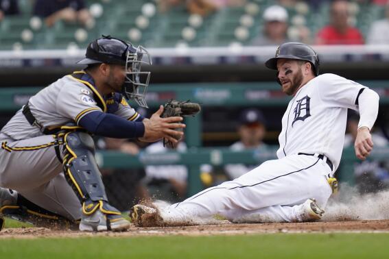 Detroit Tigers' Robbie Grossman, right, slides safely into home plate to score as Milwaukee Brewers catcher Omar Narvaez waits for the throw in the fourth inning of a baseball game in Detroit, Wednesday, Sept. 15, 2021. (AP Photo/Paul Sancya)