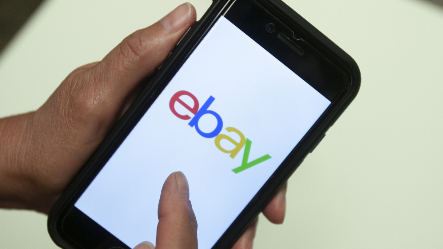 FILE - An eBay app is shown on a mobile phone, July 11, 2019, in Miami. Online marketplace behemoth eBay said it plans to no longer accept American Ex