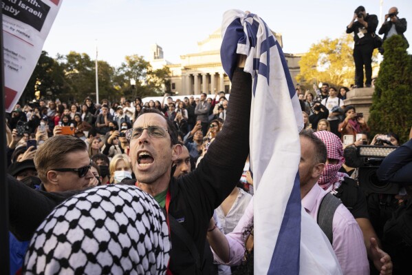 FILE - A pro-Israel demonstrator shouts at Palestinian supporters during a protest at Columbia University, Thursday, Oct. 12, 2023, in New York. As the death toll rises in the Israel-Hamas war, American colleges have become seats of anguish with many Jewish students calling for strong condemnation after civilian attacks by Hamas while some Muslim students are pressing for recognition of decades of suffering by Palestinians in Gaza. (AP Photo/Yuki Iwamura, File)