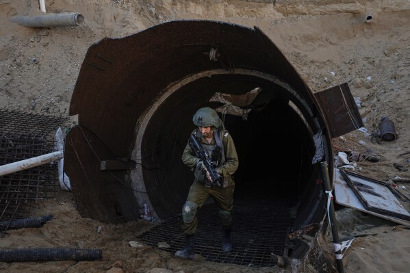 Israeli soldiers exit a tunnel that the military says Hamas militants used to attack the Erez crossing in the northern Gaza Strip, Friday, Dec. 15, 2023. The army is battling Palestinian militants across Gaza to retaliate for Hamas' Oct. 7 attack on Israel. (AP Photo/Ariel Schalit)