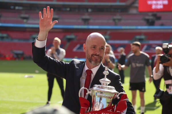 Manchester United's head coach Erik ten Hag celebrates with the trophy after winning the English FA Cup final soccer match between Manchester City and Manchester United at Wembley Stadium in London, Saturday, May 25, 2024. (AP Photo/Ian Walton)