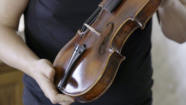 A secret note in Dachau-built 'Violin of Hope' tells a tale of survival | AP News