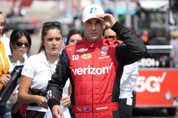 Will Power, of Australia, walks through the pit area during qualifying for an IndyCar Series auto race, Saturday, July 22, 2023, at Iowa Speedway in Newton, Iowa. (AP Photo/Charlie Neibergall)