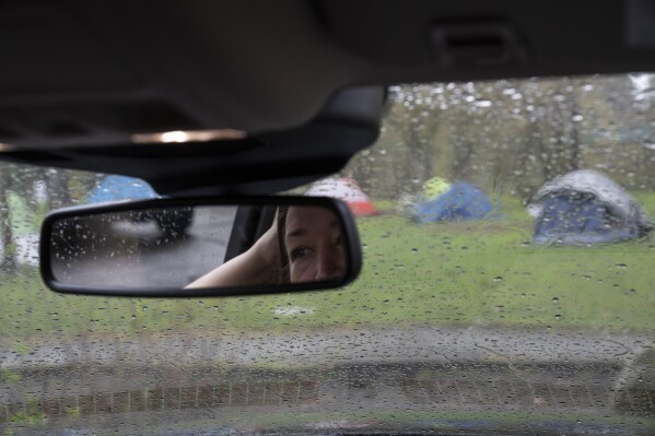 Grants Pass Mayor Sara Bristol is seen the rearview mirror while visiting Tussing Park on Friday, March 22, 2024, in Grants Pass, Ore. (AP Photo/Jenny Kane)