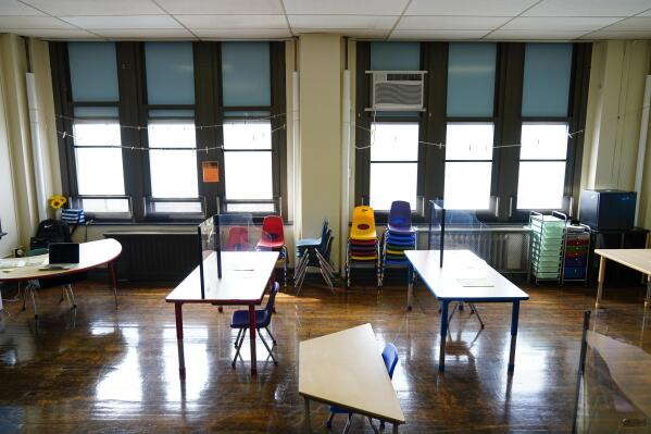 FILE - Desks are spaced apart ahead of planned in-person learning at an elementary school on March 19, 2021, in Philadelphia. The COVID-19 pandemic spared no state or region as it caused historic learning setbacks for America’s children, erasing decades of academic progress and widening racial disparities, according to results of a national test that provide the sharpest look yet at the scale of the crisis. (AP Photo/Matt Rourke, File)