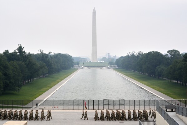 A military parade commemorating the Army's 250th anniversary, coinciding with President Donald Trump's 79th birthday, Saturday, June 14, 2025, in Washington. The Washington Monument stands center. (AP Photo/Stephanie Scarbrough)