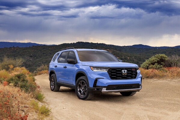 This photo provided by Honda shows the 2024 Pilot three-row SUV. Its distinctive TrailSport trim has a raised stance and all-terrain tires to enhance off-road capability. (Courtesy of American Honda Motor Co. via AP)