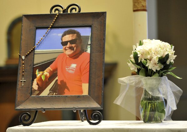 
              A photo of Jack Beaton on display next to a bouquet of flowers before his memorial service at St. Elizabeth Ann Seton Catholic Church Saturday, Oct. 7, 2017, in Bakersfield, Calif. Beaton was a victim of the mass shooting in Las Vegas on Oct. 1. (AP Photo/Silvia Flores)
            