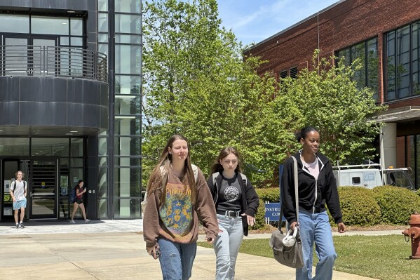 Students walk across the Gordon State College campus on Tuesday, April 16, 2024, in Barnesville, Ga. Regents of the University System of Georgia voted in a meeting at Gordon State to raise tuition and mandatory fees beginning in fall 2024. (AP Photo/Jeff Amy)