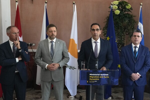 Cyprus' interior minister Konstantinos Ioannou, second right, talks to the media during a press conference as his counterparts Austria's Gerhard Karner, left, Czech's Vít Rakusan, second left, and Greece's Minister Of Immigration and Asylum Dimitris Kairides, right, stand by, during the Ministerial Summit Migration and Syria Dynamics in capital Nicosia, Cyprus, Friday, May 17, 2024. The governments of eight European Union member states say the situation inside Syria should be re-evaluated to allow for voluntary returns of Syrian refugees back to their homeland. (AP Photo/Petros Karadjias)