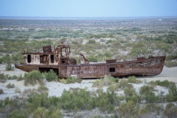 A rusting ship sits near a museum, outside Muynak, Uzbekistan, Monday, July 10, 2023. (AP Photo/Ebrahim Noroozi)
