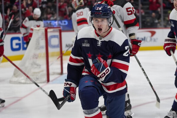 Washington Capitals center Connor McMichael celebrates his goal against the New Jersey Devils during the first period of an NHL hockey game Tuesday, Feb. 20, 2024, in Washington. (AP Photo/Alex Brandon)