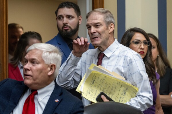 House Judiciary Committee Chair Jim Jordan, R-Ohio, center, flanked by Rep. Pete Sessions, R-Texas, left, and Rep. Lauren Boebert, R-Colo., arrives as the House Oversight and Accountability Committee holds a hearing to charge that the Justice Department interfered with a yearslong investigation into Hunter Biden, at the Capitol in Washington, Wednesday, July 19, 2023. (AP Photo/J. Scott Applewhite)
