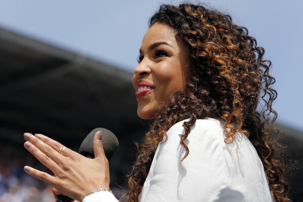 FILE - Jordin Sparks sings the national anthem before the 99th running of the Indianapolis 500 auto race at Indianapolis Motor Speedway in Indianapolis, Sunday, May 24, 2015. Sparks will return to the Indianapolis 500 this year to sing the national anthem at the May 26 "Greatest Spectacle in Racing."(AP Photo/Sam Riche)