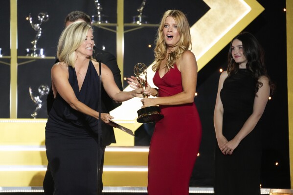 Laura Wright, left, presents the award for outstanding performance by a lead actress in a daytime drama series to Michelle Stafford for "The Young and the Restless" during the 51st Daytime Emmy Awards on Friday, June 7, 2024, at the Westin Bonaventure in Los Angeles. (AP Photo/Chris Pizzello)