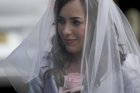 Stella Moris poses for the media and for supporters as she arrives to marry her partner the WikiLeaks founder Julian Assange in a small wedding service to be held inside the high-security Belmarsh Prison, in south east London, Wednesday,March 23, 2022. Assange, who is in a legal battle over a decision to extradite him to the U.S. to face spying charges, has been held at Belmarsh Prison since 2019, when he was arrested for skipping bail during a separate legal battle. Before that, he spent seven years inside the Ecuadorian Embassy in London to avoid extradition to Sweden to face allegations of rape and sexual assault. (AP Photo/Matt Dunham)