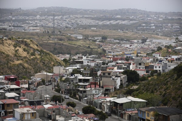 Dense housing developments are visible in the Santa Fe section of Tijuana, Mexico, on Friday, May 12, 2023. Among the last cities downstream to receive water from the shrinking Colorado River, Tijuana is staring down a water crisis. Part of the challenge for Tijuana's aging infrastructure is the city's layout: Water is pumped up and down steep hills and canyons to reach developments that have sprawled in every direction as the city has grown. (AP Photo/Carlos A. Moreno)