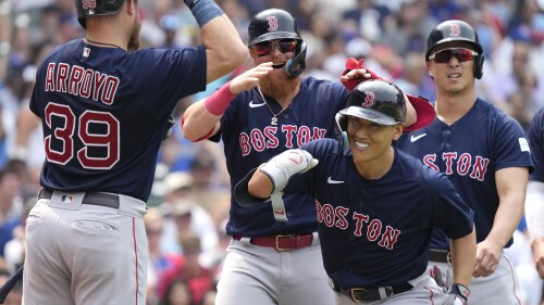 Boston Red Sox's Masataka Yoshida, second from right, of Japan, celebrates with Christian Arroyo, left, Justin Turner, second from left, and Rob Refsnyder after hitting a grand slam during the fifth inning of a baseball game against the Chicago Cubs in Chicago, Sunday, July 16, 2023. (AP Photo/Nam Y. Huh)