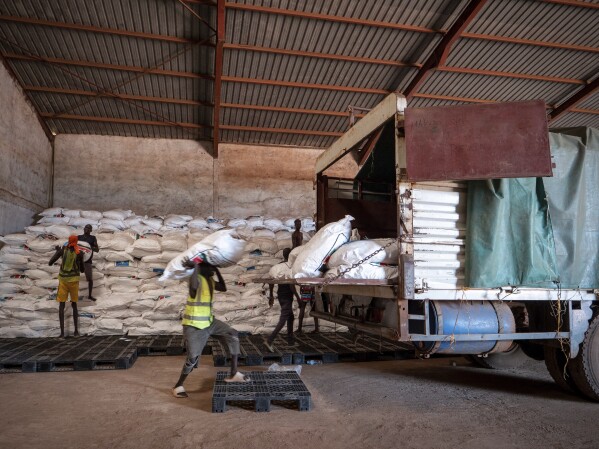 Workers load food aid onto a Fogbow truck as part of an aid program operated by retired American military officers at an airport in Juba, South Sudan, Monday, June 9, 2025. (AP Photo/ Florence Mettiaux)