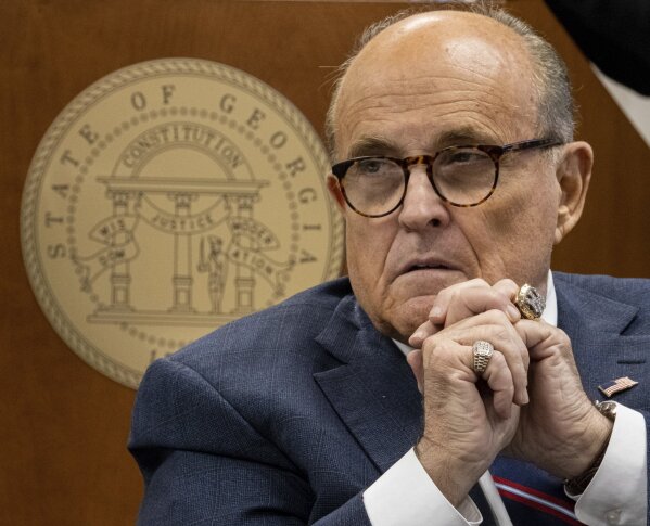 Rudi Giuliani listens to testimony during a subcommittee of the state Senate judiciary committee meeting at the State Capitol in Atlanta on Thursday, Dec. 3, 2020. Giuliani brought fellow lawyers and witnesses who alleged serious voting problems in Georgia and asked that the State Legislature chose Georgia's electors. (Ben Gray/Atlanta Journal-Constitution via AP)