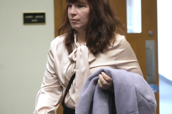 Kimberly Zapata, the former deputy director of the Milwaukee Election Commission, enters court before her jury trial in a Milwaukee County Courthouse in Milwaukee on Monday, March 18, 2024. Zapata is accused of fraudulently requesting absentee ballots reserved for members of the military and sending them to GOP state Rep. Janel Brandtjen, who is known for embracing conspiracy theories about the 2020 election. (Mike De Sisti/Milwaukee Journal-Sentinel via AP)
