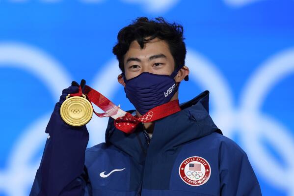 Nathan Chen of the United States displays his gold medal during the medal ceremony for the men's free skate figure skating at the 2022 Winter Olympics, Thursday, Feb. 10, 2022, in Beijing. (AP Photo/Jae C. Hong)