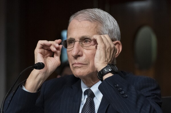 FILE - Dr. Anthony Fauci, director of the National Institute of Allergy and Infectious Diseases, adjusts his glasses during a Senate Health, Education, Labor, and Pensions Committee hearing on Capitol Hill, Nov. 4, 2021, in Washington. Fauci is expected to testify before Congress early next year as part of Republicans鈥� yearslong investigation into the origins of COVID-19 and the U.S. response to the disease. Fauci will sit for transcribed interviews in early January and a public hearing at a later date. (AP Photo/Alex Brandon, File)