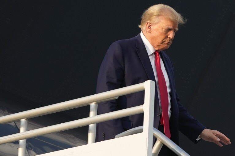 Former President Donald Trump steps off his plane as he arrives at Hartsfield-Jackson Atlanta International Airport, Thursday, Aug. 24, 2023, in Atlanta. (AP Photo/Alex Brandon)