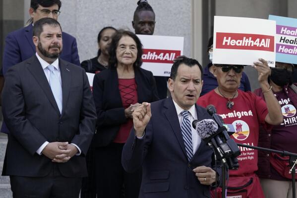 California Assembly Speaker Anthony Rendon, D-Lakewood, center, speaks in support of health care for all low-income immigrants living in the country illegally during a rally at the Capitol Sacramento, Calif., on Wednesday, June 29, 2022. Gov. Gavin Newsom is expected to sign a $307.9 billion operating budget on Thursday June 30, 2022, that makes all low-income adults eligible for the state's medicaid program regardless of their immigration status. (AP Photo/Rich Pedroncelli)