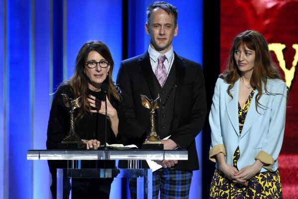 
              Nicole Holofcener, left, and Jeff Whitty accept the award for best screenplay for "Can You Ever Forgive Me?" with director Marielle Heller, right, looking on at the 34th Film Independent Spirit Awards on Saturday, Feb. 23, 2019, in Santa Monica, Calif. (Photo by Chris Pizzello/Invision/AP)
            