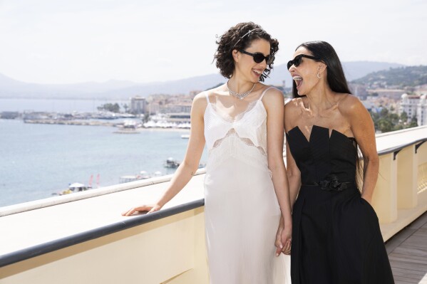 Margaret Qualley, left, and Demi Moore pose for photographers at the photo call for the film 'The Substance' at the 77th international film festival, Cannes, southern France, Sunday, May 19, 2024. (Photo by Scott A Garfitt/Invision/AP)