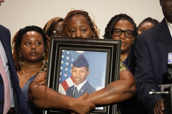CORRECTS SERVICE BRANCH TO U.S. AIR FORCE INSTEAD OF U.S. NAVY - Chantemekki Fortson, mother of Roger Fortson, a U.S. Air Force senior airman, holds a photo of her son during a news conference with attorney Ben Crump, Thursday, May 9, 2024, in Fort Walton Beach, Fla. Fortson was shot and killed by police in his apartment, May 3, 2024. (AP Photo/Gerald Herbert)