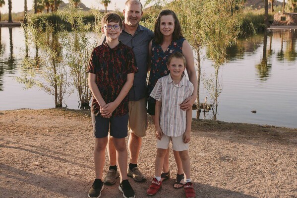This photo provided by Samantha Rose Photography LLC shows North Dakota Sen. Doug Larsen, second from left, with his wife, Amy, and their two sons, Christian and Everett, on Saturday, Sept. 29, 2023, at Papago Park in Phoenix, Ariz. All four of them died the following day, Sunday, Sept. 30, in a plane crash near Moab, Utah. (Samantha Brammer/Samantha Rose Photography LLC via AP)