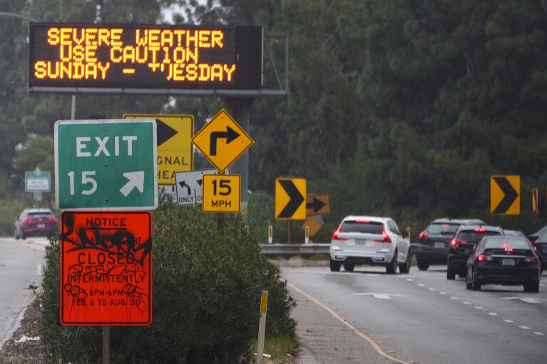 A sign warns motorists of severe weather on California State Route 2 (SR-2) in Los Angeles, Sunday, Feb. 4, 2024.  (AP Photo/Damian Dovarganes)