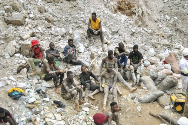 Miners take a break during the mine rescue mission on Sunday, Dec. 3, 2023 in Chingola, around 400 kilometres (248 miles) north of the capital Lusaka, Zambia. Seven miners were confirmed dead and more than 20 others were missing and presumed dead after heavy rains caused landslides that buried them inside tunnels they had been digging illegally at a copper mine in Zambia, police and local authorities said Saturday. (AP Photo)