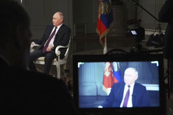 In this photo released by Sputnik news agency on Friday, Feb. 9, 2024, Russian President Vladimir Putin attends an interview with former Fox News host Tucker Carlson at the Kremlin in Moscow, Russia, Tuesday, Feb. 6, 2024. (Gavriil Grigorov, Sputnik, Kremlin Pool Photo via AP)