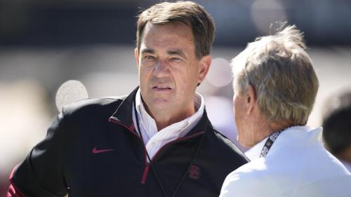 FILE - Southern California athletic director Mike Bohn, left, chats with Gary Barnett, former head football coach at Colorado, as players warm up before the first half of an NCAA college football game Saturday, Oct. 2, 2021, in Boulder, Colo. Southern California athletic director Mike Bohn has resigned. USC confirmed the 62-year-old Bohn's resignation Friday, May 19, 2023, roughly 3 1/2 years after he succeeded Lynn Swann in the high-profile job. (AP Photo/David Zalubowski, File)